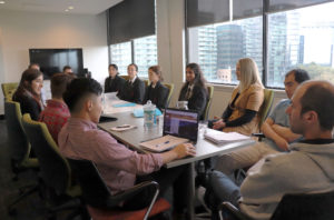 Megantic mentors sitting with students in the conference room